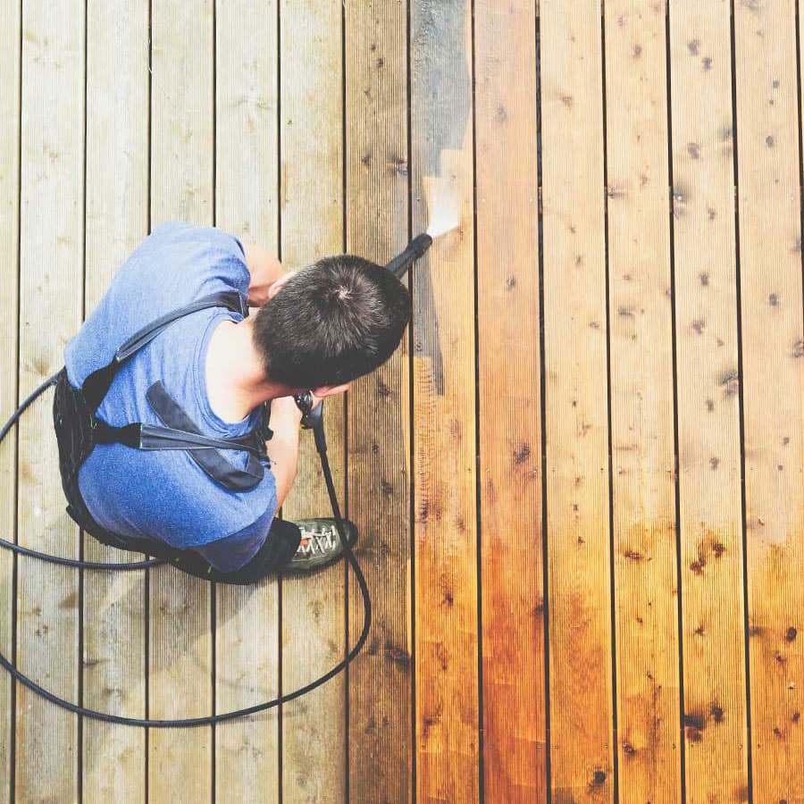 DB Powerclean pressure washing decking, dirty and clean side by side